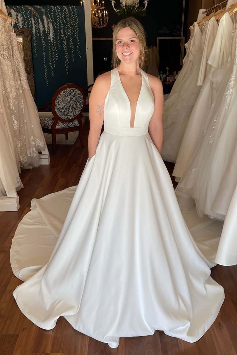 Elegant Ivory Plunging Halter Mermaid Style Bridal Dress with Functional Pockets